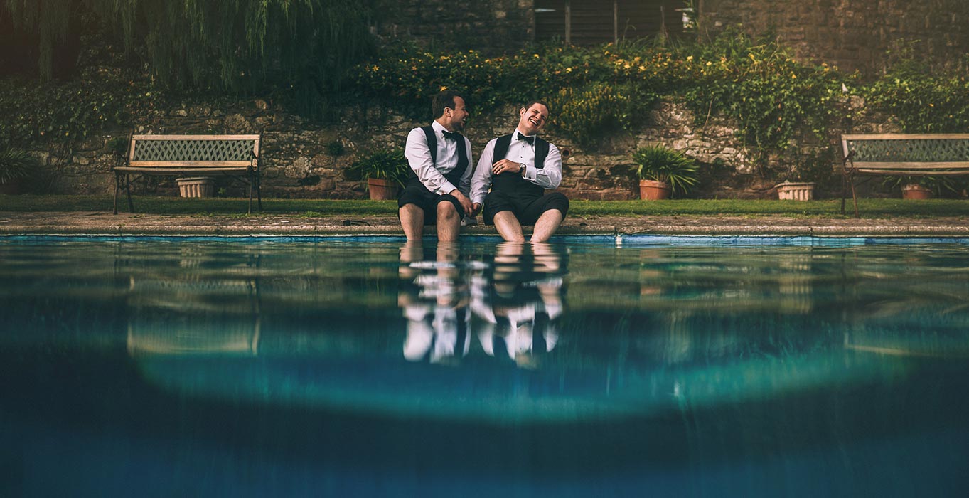 Groomsmen sitting by the pool